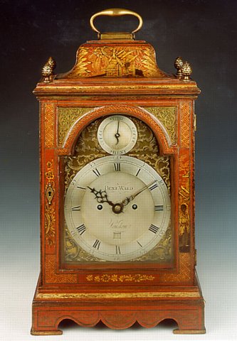 A George III bracket clock in an inverted bell top case decorated with well patinated red lacquer